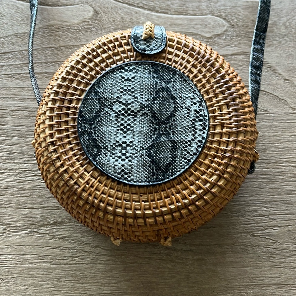 Romeo Roma straw bag with black snake leather pattern detailing.